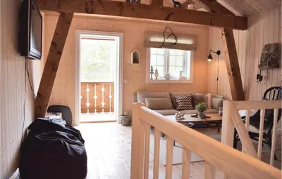 a living room with a couch and a table at Three-Bedroom Holiday Home In Hovet in Hovet