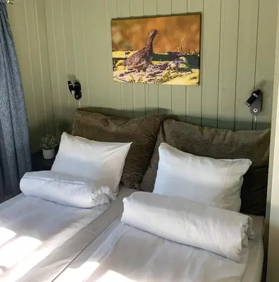 two white pillows sitting on a couch in a room at Vågåvatnet Feriesenter in Vågåmo