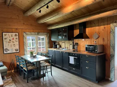 a kitchen with a table and a stove top oven at Vågåvatnet Feriesenter in Vågåmo