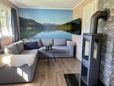 a living room with a couch and a fireplace at Vågåvatnet Feriesenter in Vågåmo