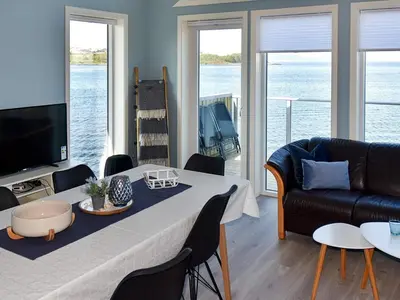 a living room with a table and a couch at 10 person holiday home in Brattvåg in Brattvåg