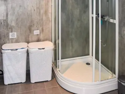 two trash cans in a bathroom with a shower at 10 person holiday home in Brattvåg in Brattvåg