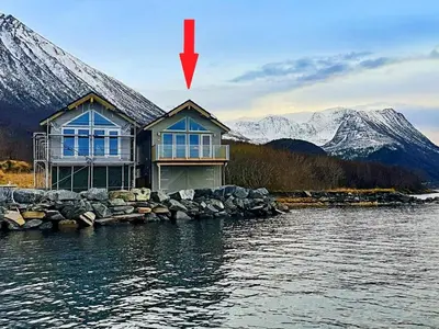 a house on the shore of a body of water at 10 person holiday home in Brattvåg in Brattvåg