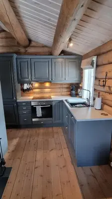 a kitchen with blue cabinets and a counter top at Koselig familiehytte sentralt på Skeikampen til leie in Svingvoll