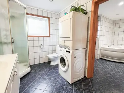 a bathroom with a washer and dryer in it at 6 person holiday home in Leikanger in Leikanger