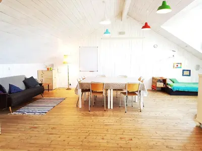 a living room with a table and a couch at Drengestua på Flagstad Østre in Hamar