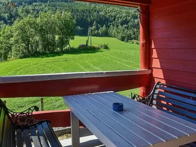 a blue bench sitting on a porch with a window at 8 person holiday home in olden in Olden