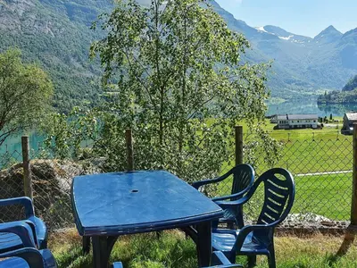 a blue table and chairs with a view of a mountain at 8 person holiday home in olden in Olden