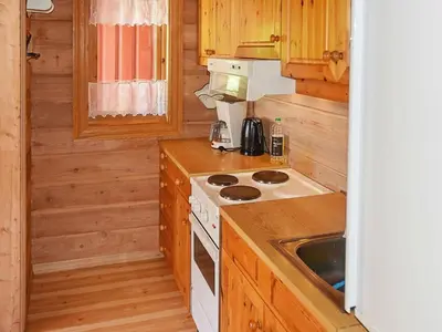 a small kitchen with a stove and a sink at 8 person holiday home in olden in Olden