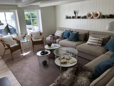 a living room with a couch and a table at Olsens Pensjonat in Veiholmen