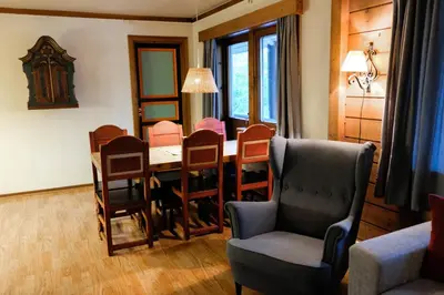 a living room with a dining room table and chairs at Hemsetunet Apartments in Hemsedal