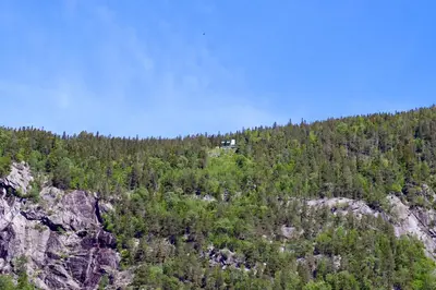 a house on top of a mountain with trees at Rjukan Gjestehus in Rjukan