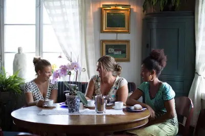 a group of three women sitting at a table at Nutheim Gjestgiveri in Flatdal