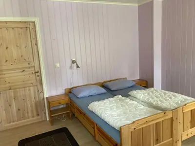 a bedroom with a bed with blue pillows at Roste Hyttetun og Camping in Os