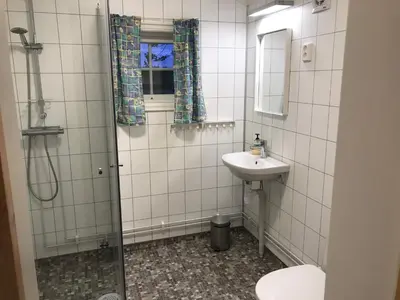 a bathroom with a sink and a shower at Roste Hyttetun og Camping in Os