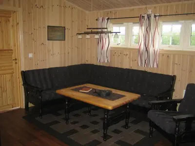 a living room with a couch and a table at Roste Hyttetun og Camping in Os