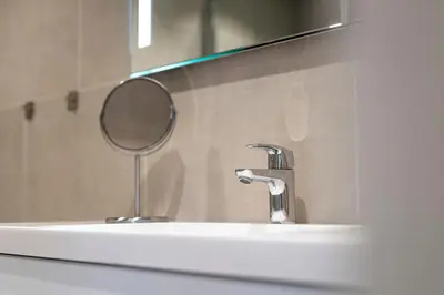 a bathroom sink with a mirror and a faucet at Skaimsberg Holiday Apartments in Aurland