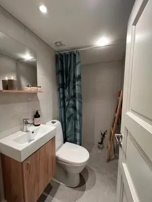 a bathroom with a white toilet and a sink at Sørlia hytte in Hafjell