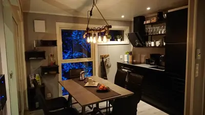 a small kitchen with a table and a window at Hardanger Panorama Lodge in Ulvik