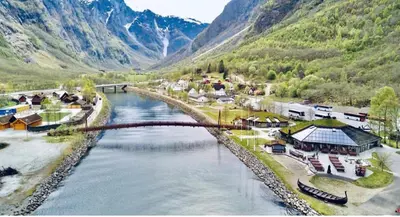 an aerial view of a river with a bridge at Gudvangen Budget Hotel in Gudvangen