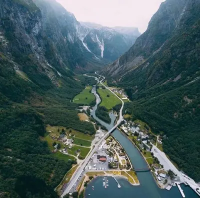 an aerial view of a river in a mountain valley at Gudvangen Budget Hotel in Gudvangen