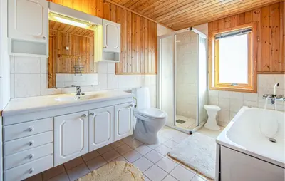 a bathroom with a sink and a toilet and a shower at 5 Bedroom Gorgeous Home In Fjørtoft in Fjørtoft