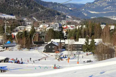 a group of people on a ski lift in the snow at Hafjell Alpinlandsby Pluss in Hafjell