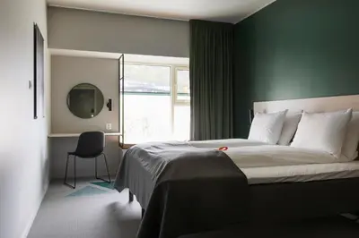 a bedroom with a large bed and a window at Citybox Bergen Danmarksplass in Bergen