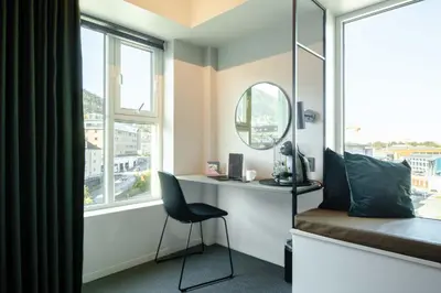 a bedroom with a desk and a chair in front of a window at Citybox Bergen Danmarksplass in Bergen