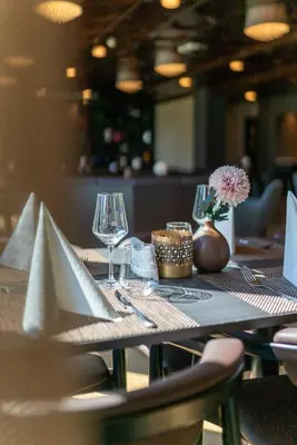 a table with wine glasses and napkins on it at Dreges Hotell - by Classic Norway Hotels in Stranda