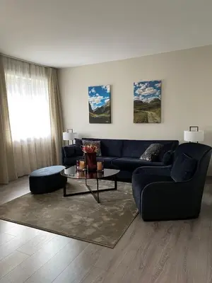 a living room with a couch and a table at Dreges Hotell - by Classic Norway Hotels in Stranda