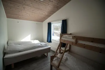 a bedroom with a bunk bed and a window at Dombåstun Motel in Dombås