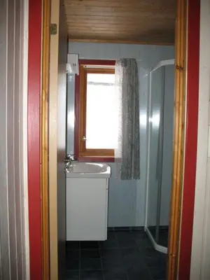 a small bathroom with a sink and a window at Seljestad Cottages in Skare