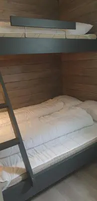 a bunk bed with white sheets on top of it at Oppdal Alpintun, Stølen øvre - ski in ski out in Oppdal