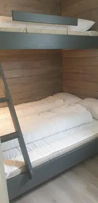 a bunk bed with a ladder on top of it at Oppdal Alpintun, Stølen øvre - ski in ski out in Oppdal