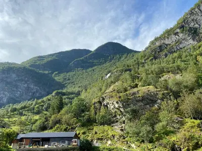 a house on the side of a mountain at Brekke Gard Hostel in Flåm
