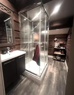 a glass shower in a bathroom with a sink at Hafjell Grenda lejligheder og hytter in Hafjell