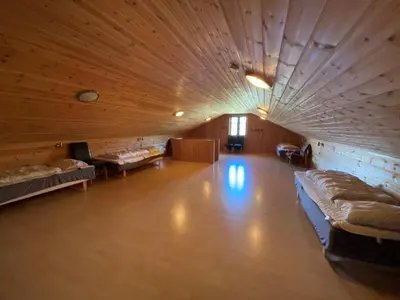 a large room with couches and beds in it at Hafjell Grenda lejligheder og hytter in Hafjell