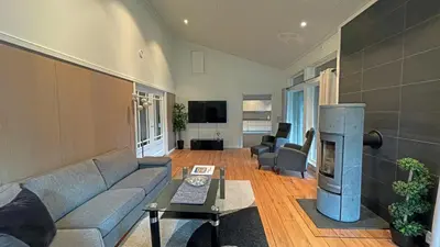 a living room with a couch and a tv at Otnes Sør - Luxury 140m2 in Aurland