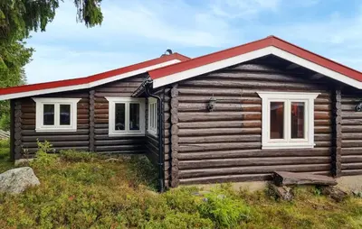 a log cabin with a red roof and two windows at Three-Bedroom Holiday Home In Sjusjoen in Sjusjøen