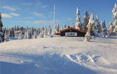 a cabin on a ski slope with snow covered trees at Three-Bedroom Holiday Home In Sjusjoen in Sjusjøen