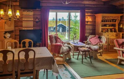 a living room with a table and chairs and a television at Three-Bedroom Holiday Home In Sjusjoen in Sjusjøen