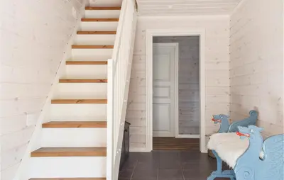 a staircase in a house with white walls at 3 Bedroom Stunning Home In Sjusjøen in Sjusjøen