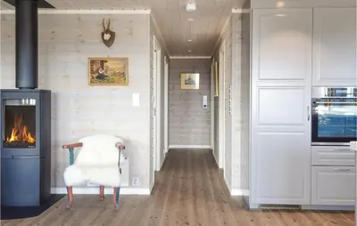 a hallway with a fireplace in a house at 3 Bedroom Stunning Home In Sjusjøen in Sjusjøen