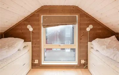 a small room with two beds and a window at 3 Bedroom Beautiful Home In Sjusjøen in Sjusjøen