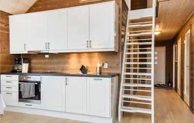 a kitchen with white cabinets and a ladder at 3 Bedroom Beautiful Home In Sjusjøen in Sjusjøen