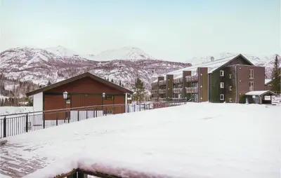 a snow covered parking lot in front of a building at Lovely Apartment In Hemsedal With Sauna in Hemsedal