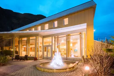 a building with a fountain in front of it at Klingenberg Hotel - Årdal in Årdalstangen