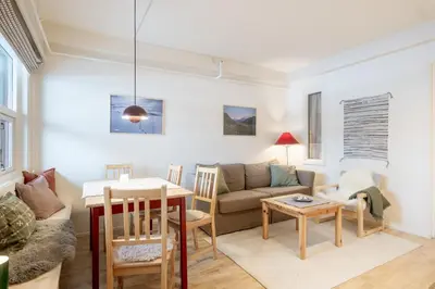 a living room with a couch and a table at Supersentralt ski inn ski out in Geilo