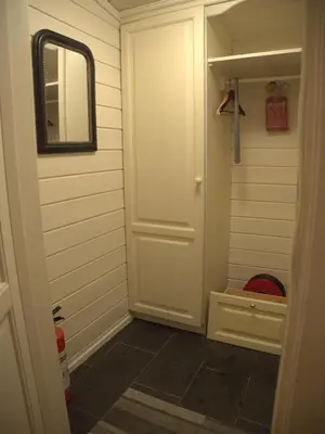a bathroom with a white door and a mirror at Supersentralt ski inn ski out in Geilo